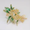 botanical brooch with green leaves and pearl