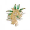 green floral brooch with golden flowers and pearl