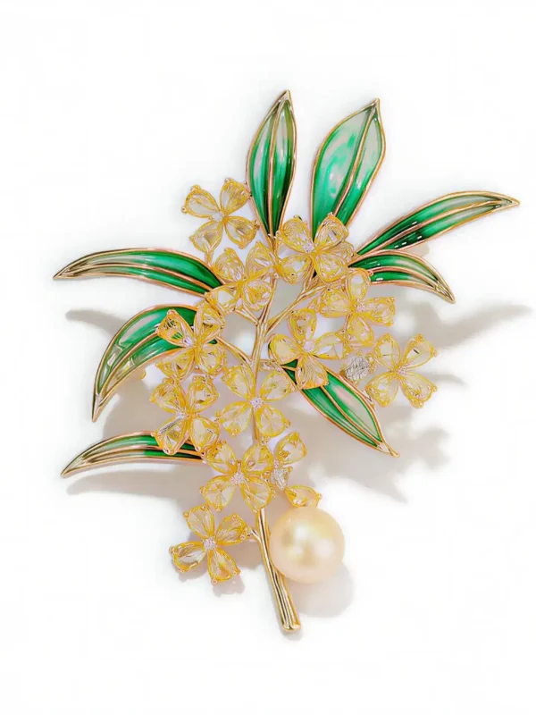 green floral brooch with golden flowers and pearl
