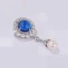 Blue Crystal Pearl Brooch Side Angle Angled view of blue crystal brooch with pearl drop