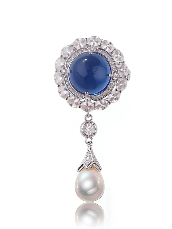 Blue crystal brooch with pearl drop in a halo design