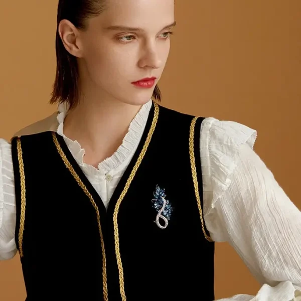 Midnight Blue Crystal Leaf Brooch Worn on Outfit Woman wearing a midnight blue crystal leaf brooch on a black vest