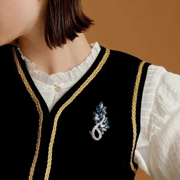 Close-Up of Midnight Blue Crystal Leaf Brooch Close-up view of a model wearing a blue crystal leaf brooch
