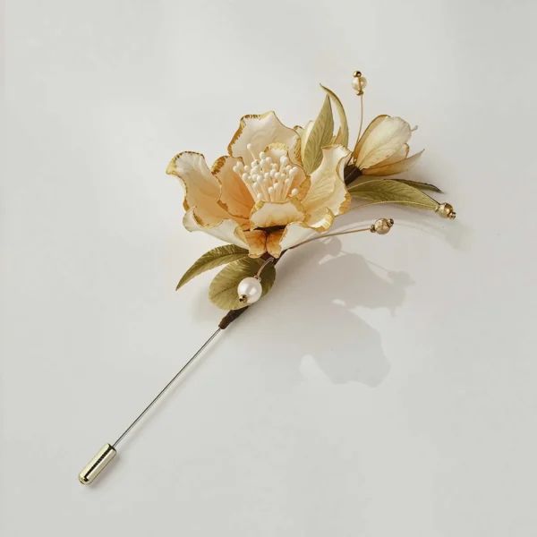 Silk Blossom Brooch Angle View Angled view of gold-trimmed silk blossom brooch