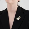 White Blossom Branch Brooch Styled on Outfit Woman wearing a white blossom branch brooch on a black blazer